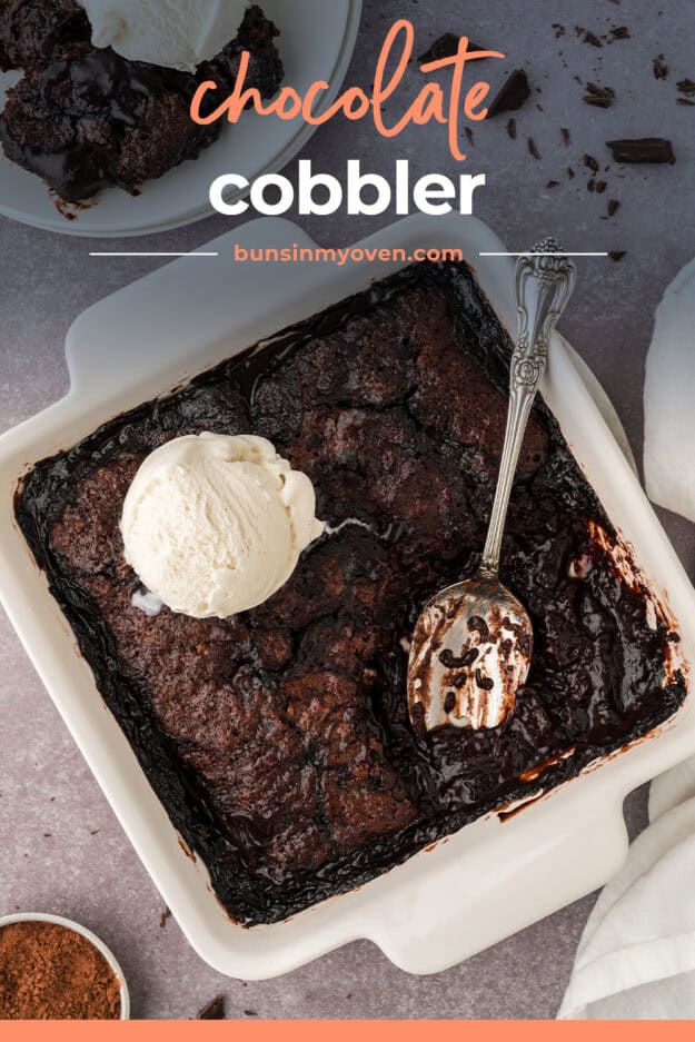 Chocolate cobbler recipe in baking dish with vanilla ice cream on top.