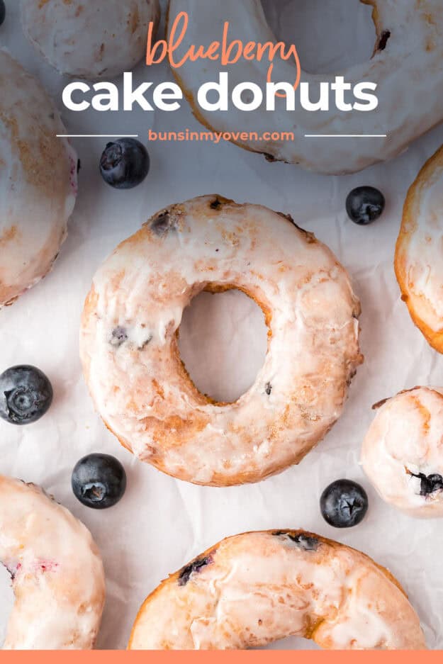 Blueberry donut surrounded by blueberries.