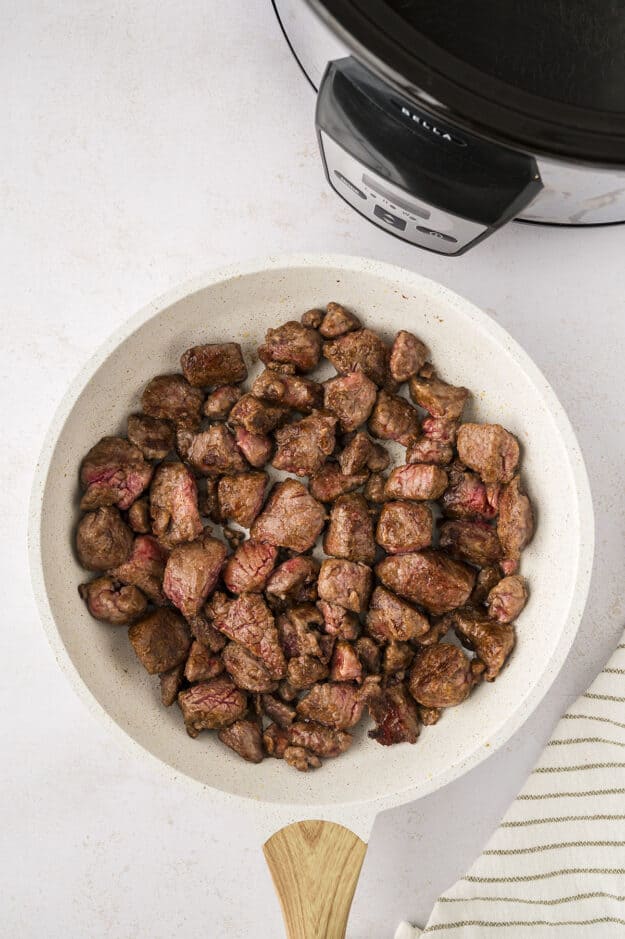 Seared stew meat in skillet.