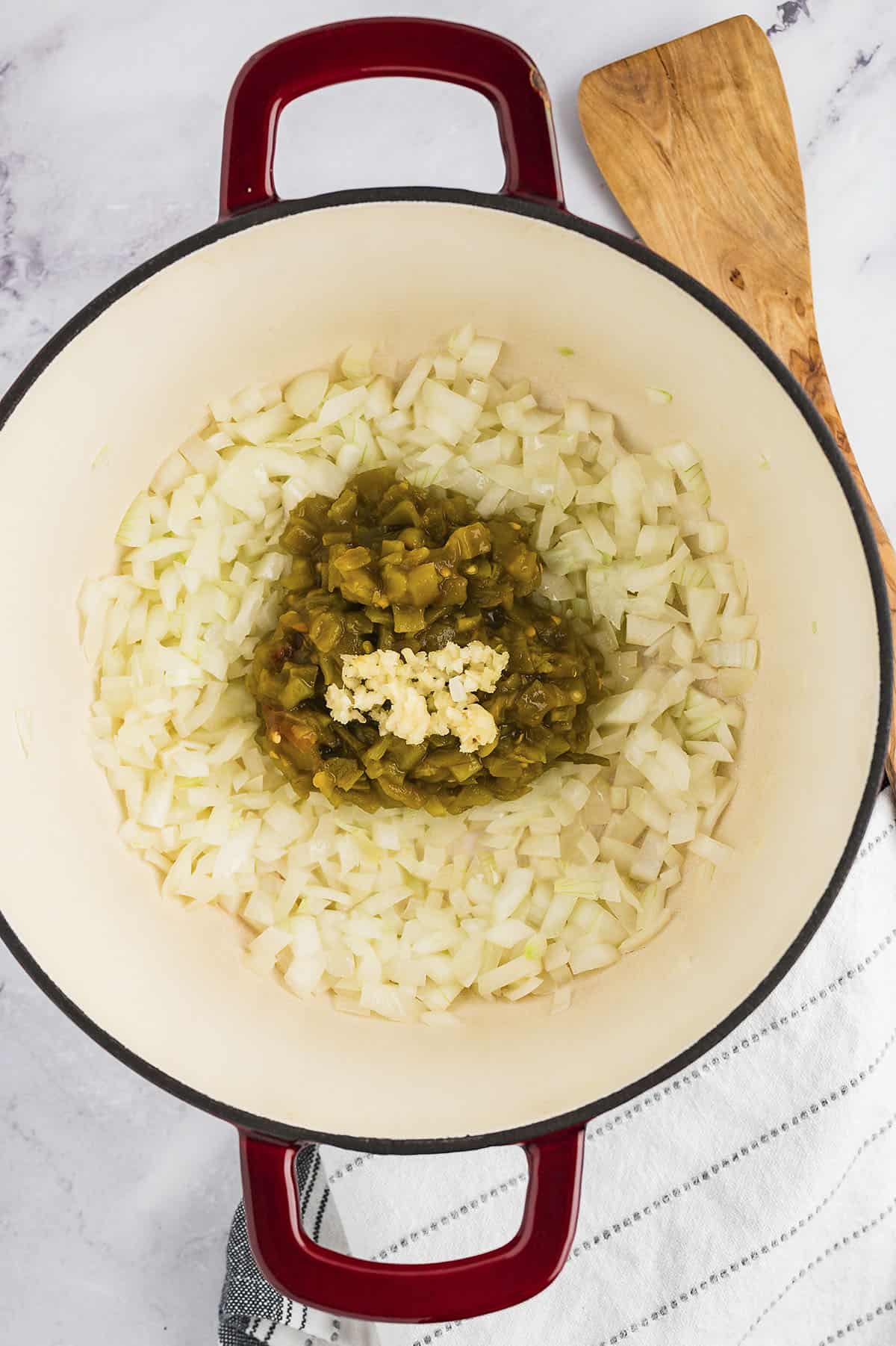 Onion, garlic, and chiles in pot.