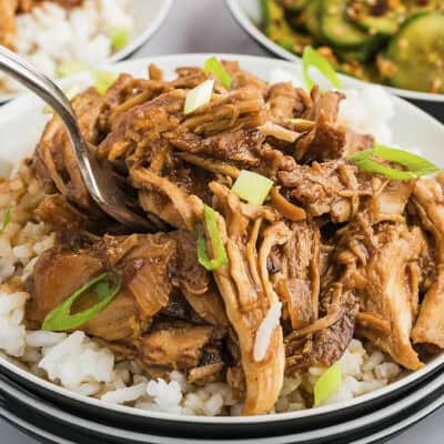 Bourbon crockpot chicken on plate with white rice.
