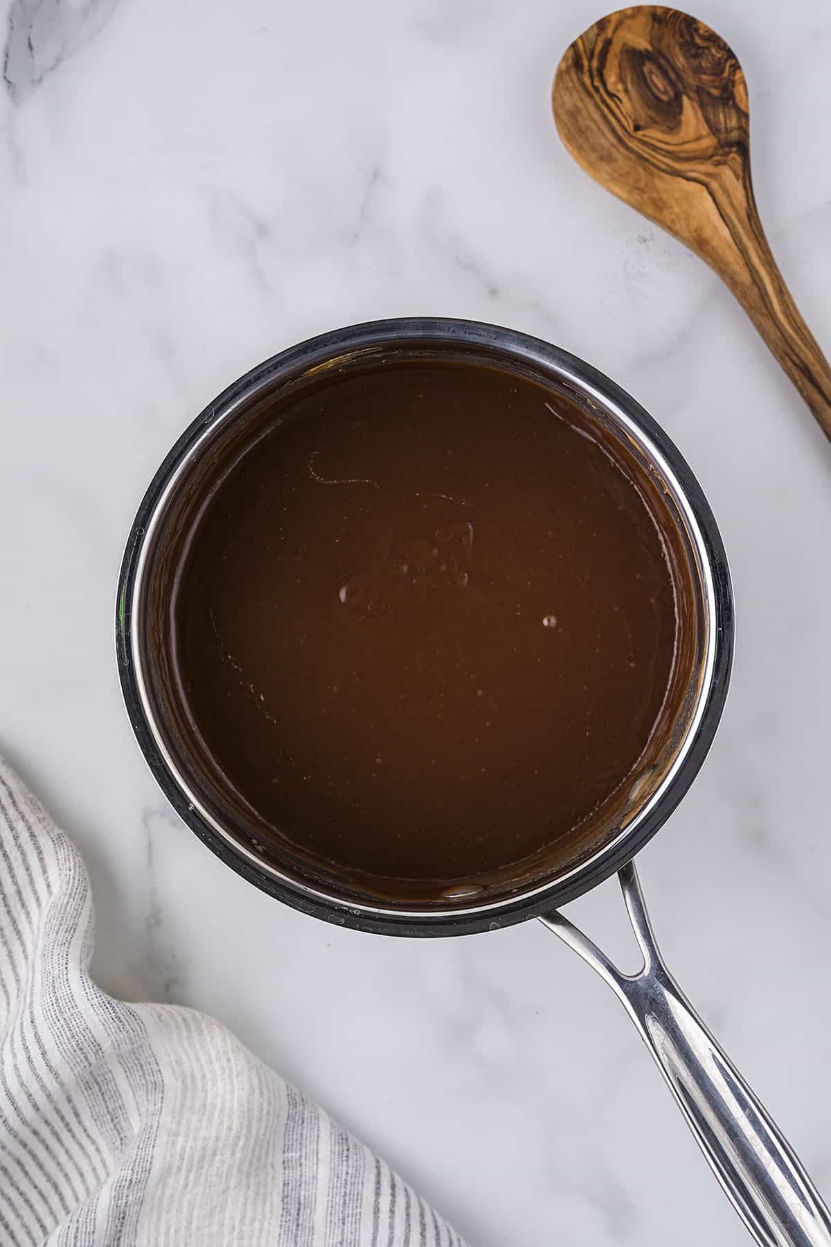 Boiled chocolate frosting in pan.