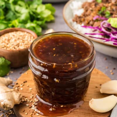 Korean BBQ Sauce in small jar on wooden board.