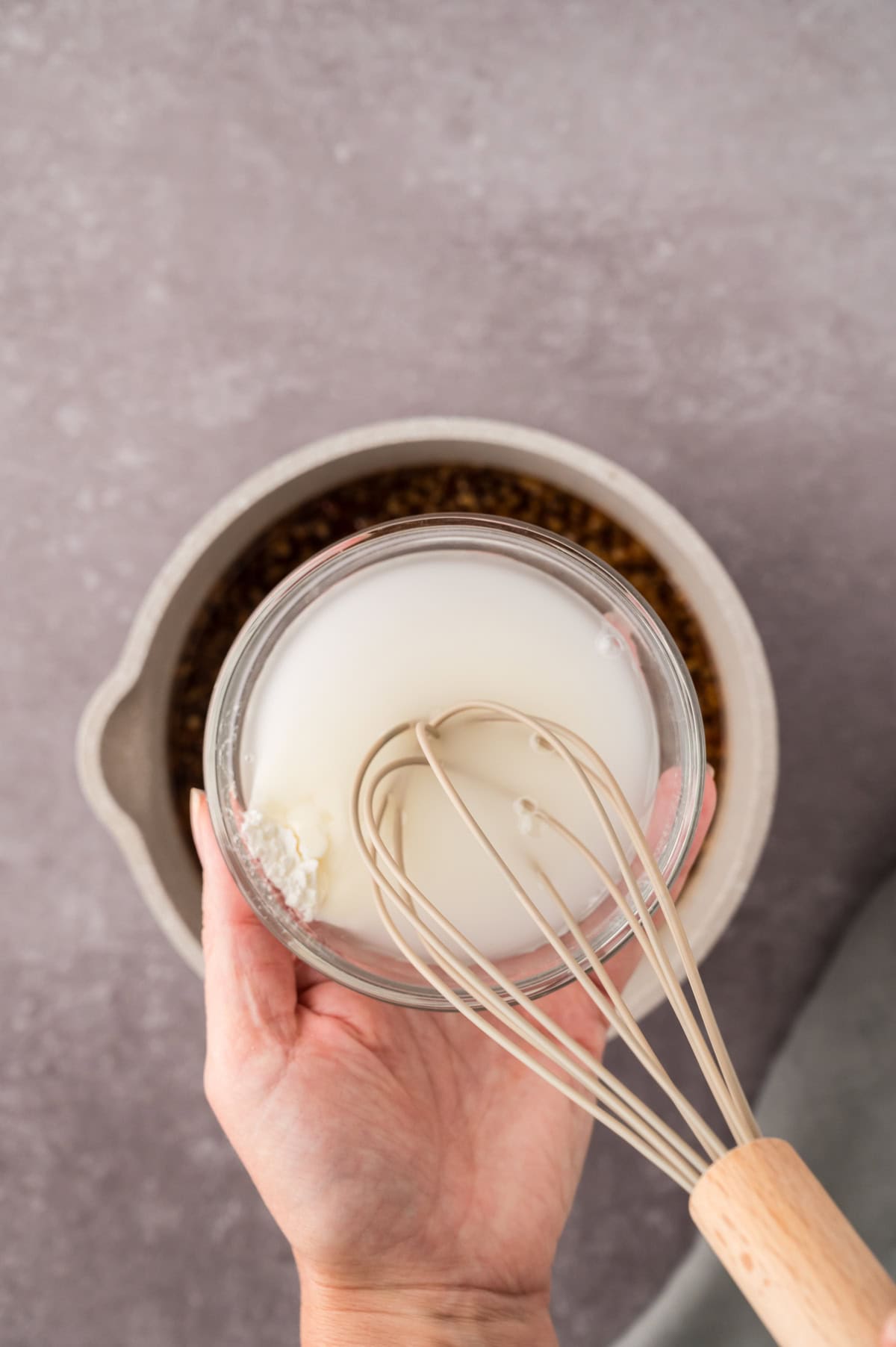 Cornstarch and water being whisked together.