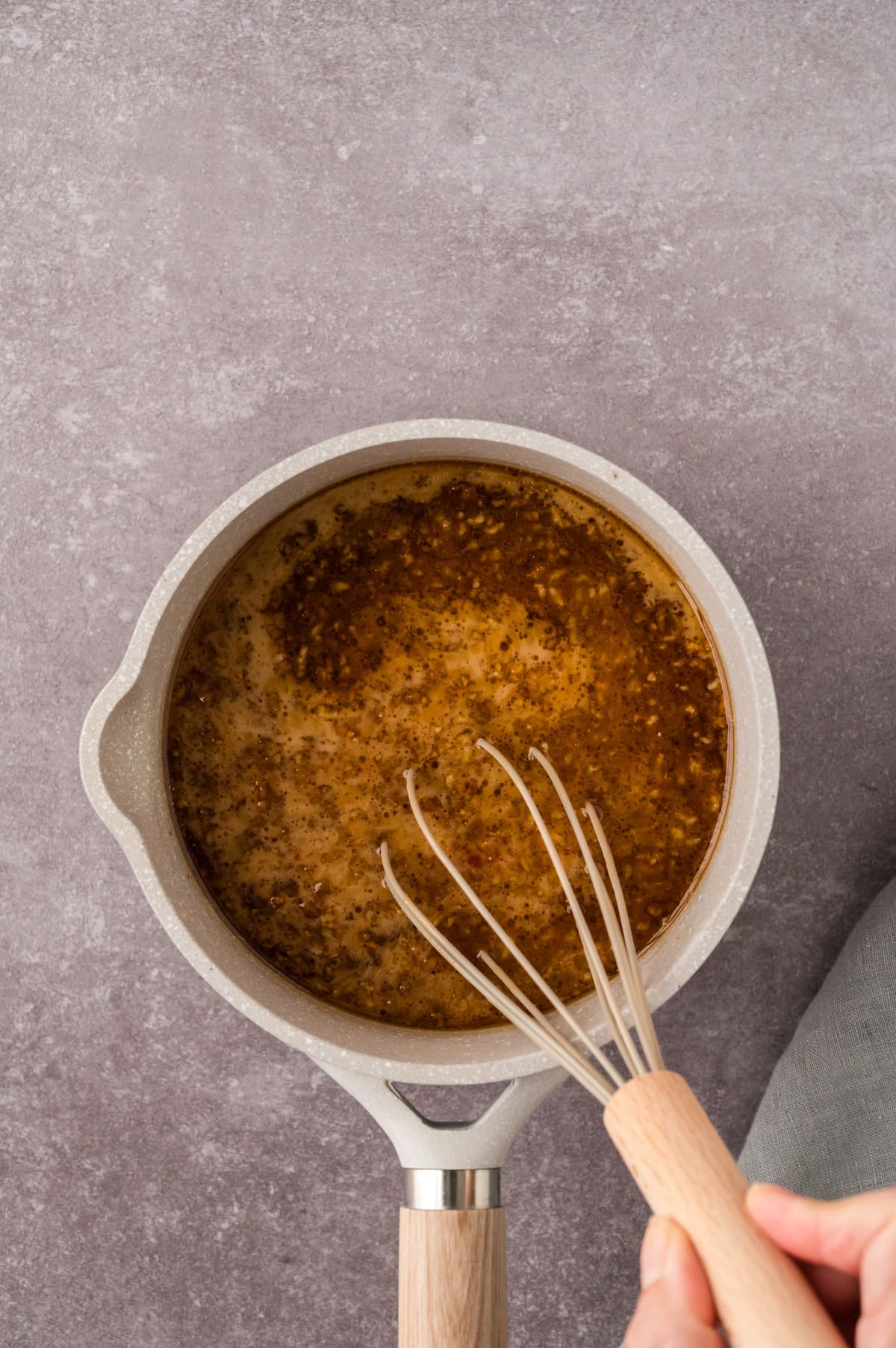 Korean barbecue sauce recipe being whisked together on stove.