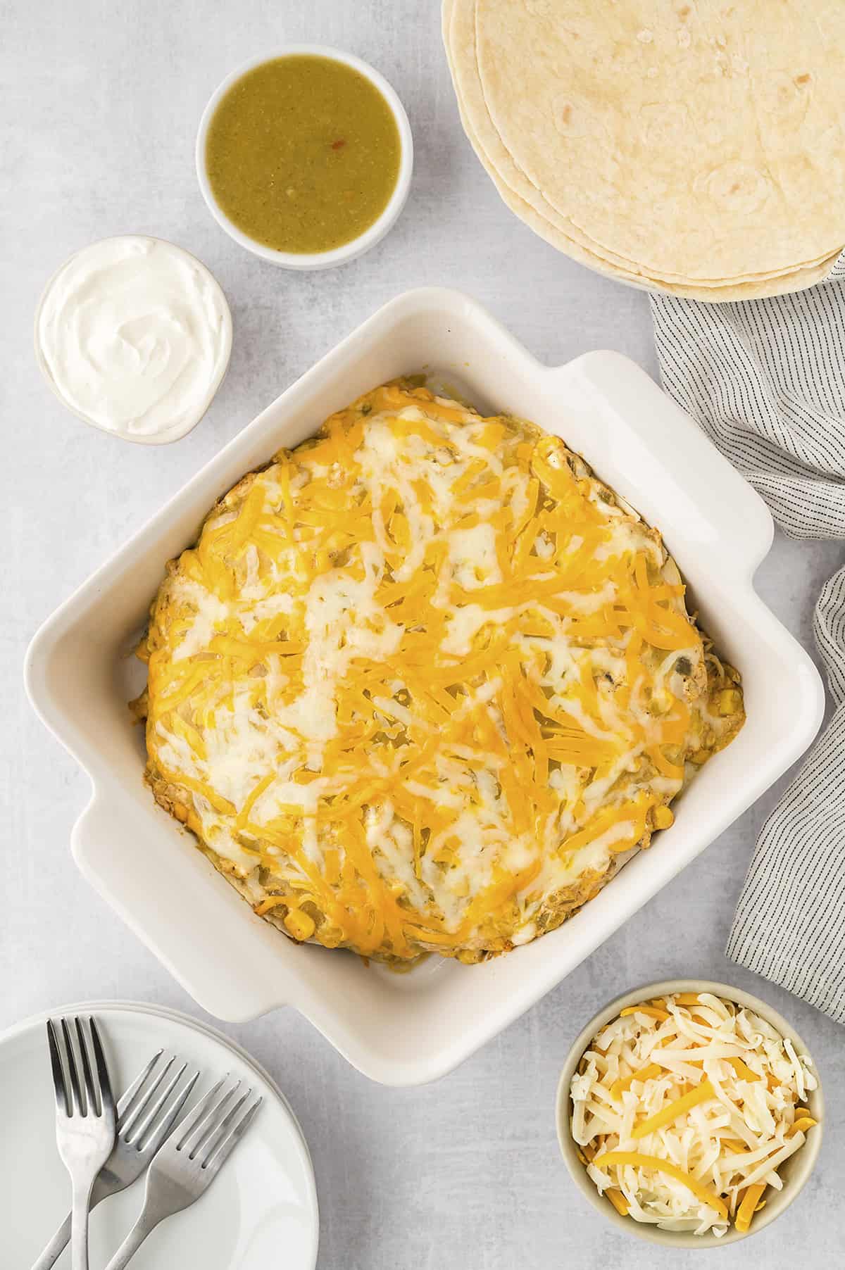 Baked enchilada casserole in white dish.