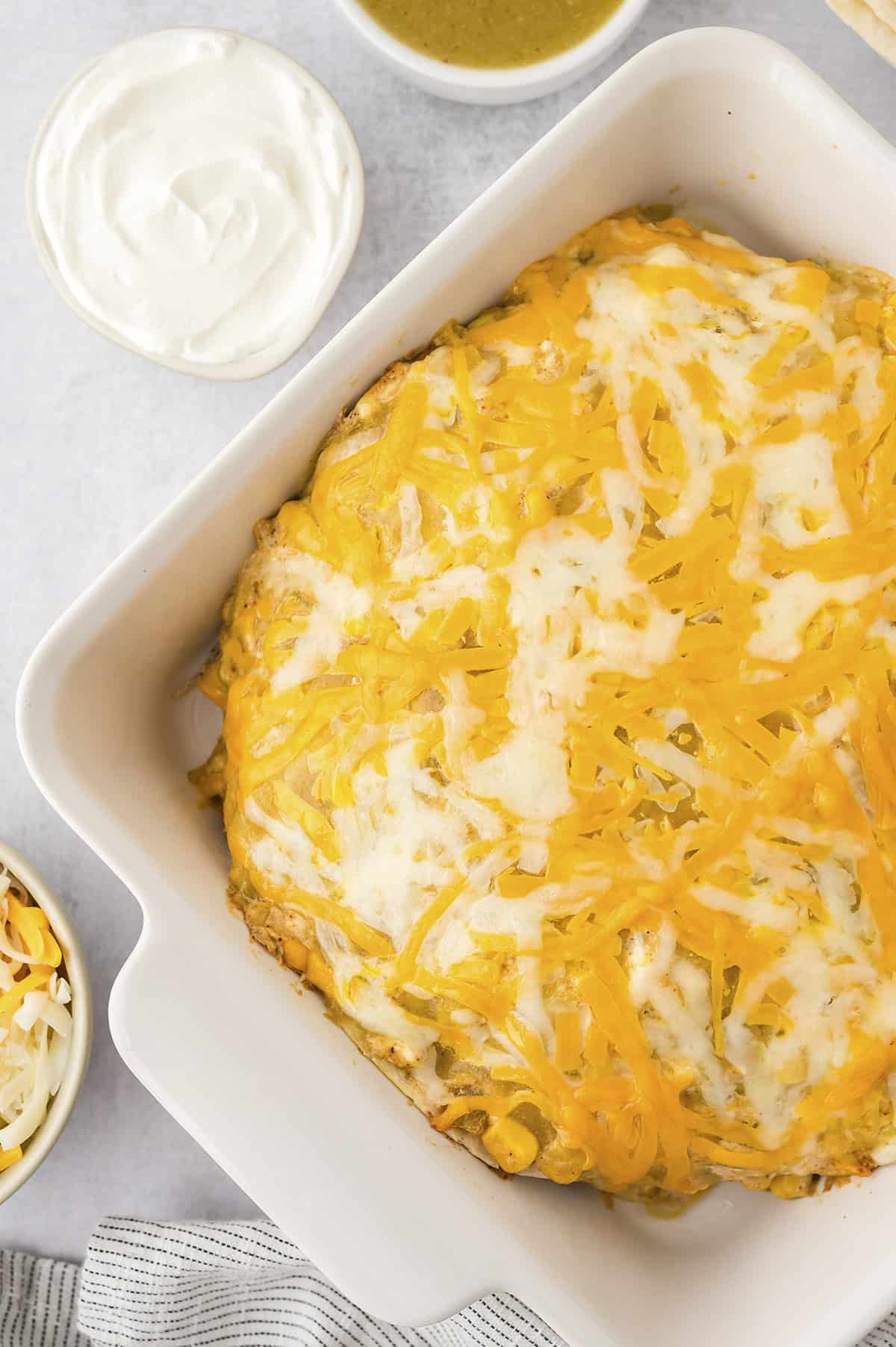 Cheesy baked enchilada casserole in pan.