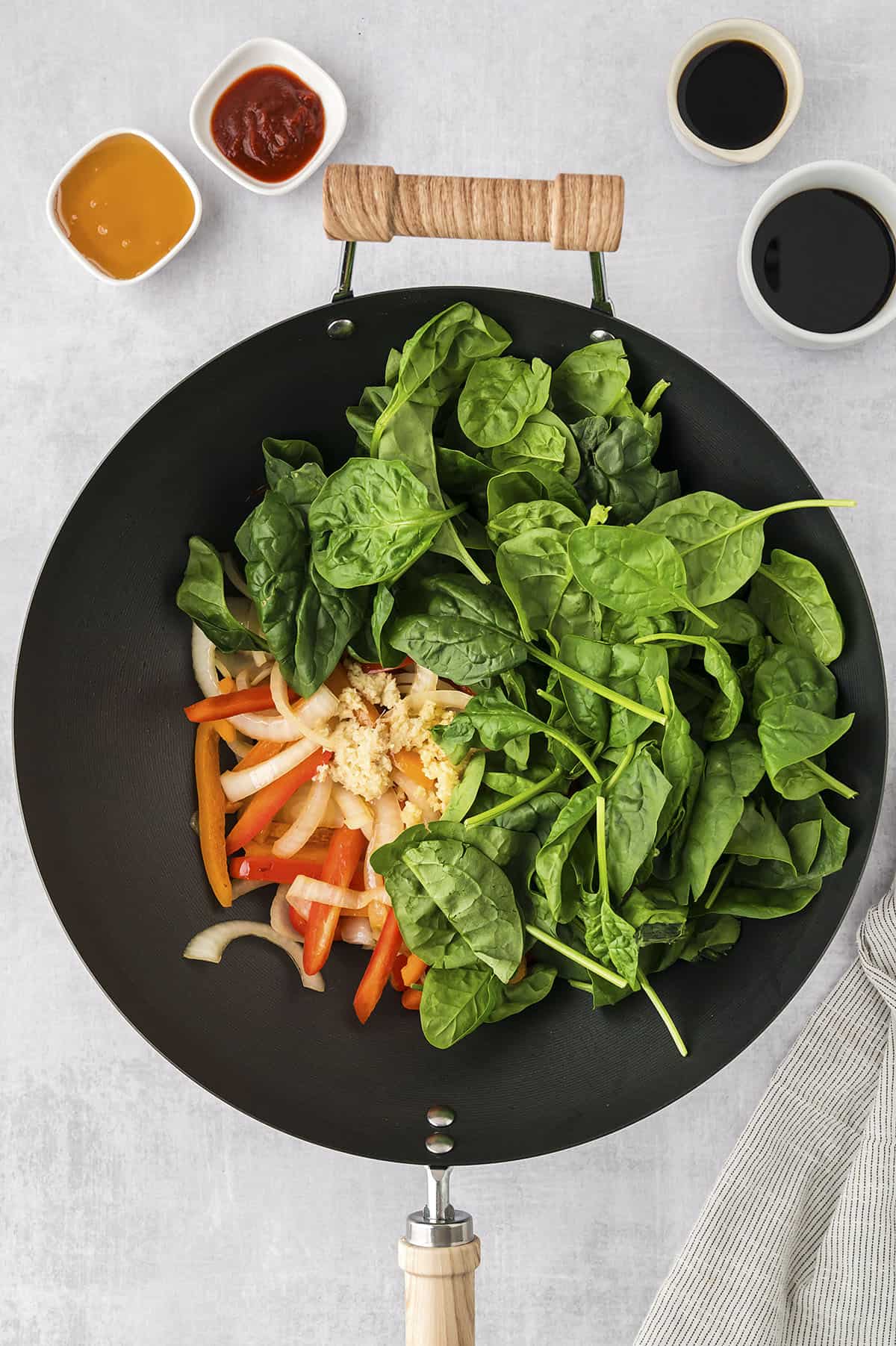 Veggies being cooked in wok.