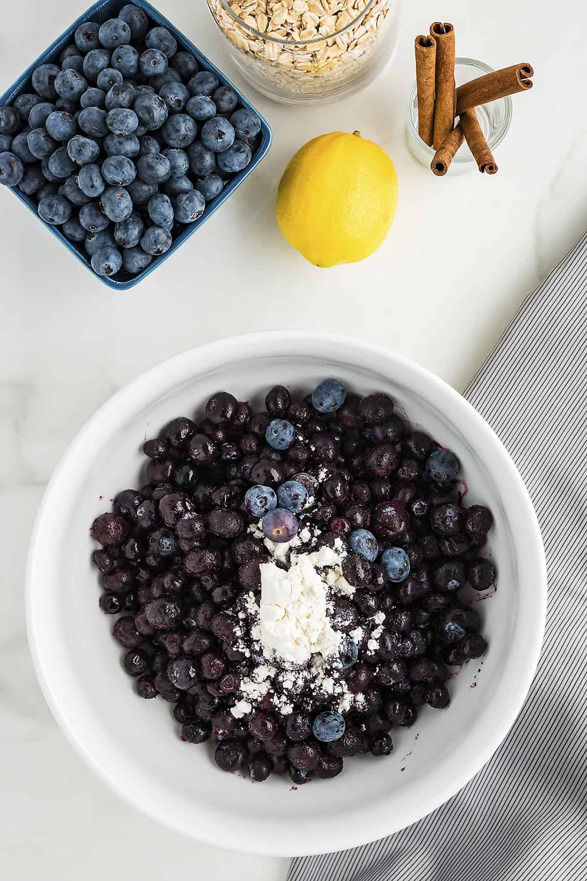 Blueberries in a bowl with flour.