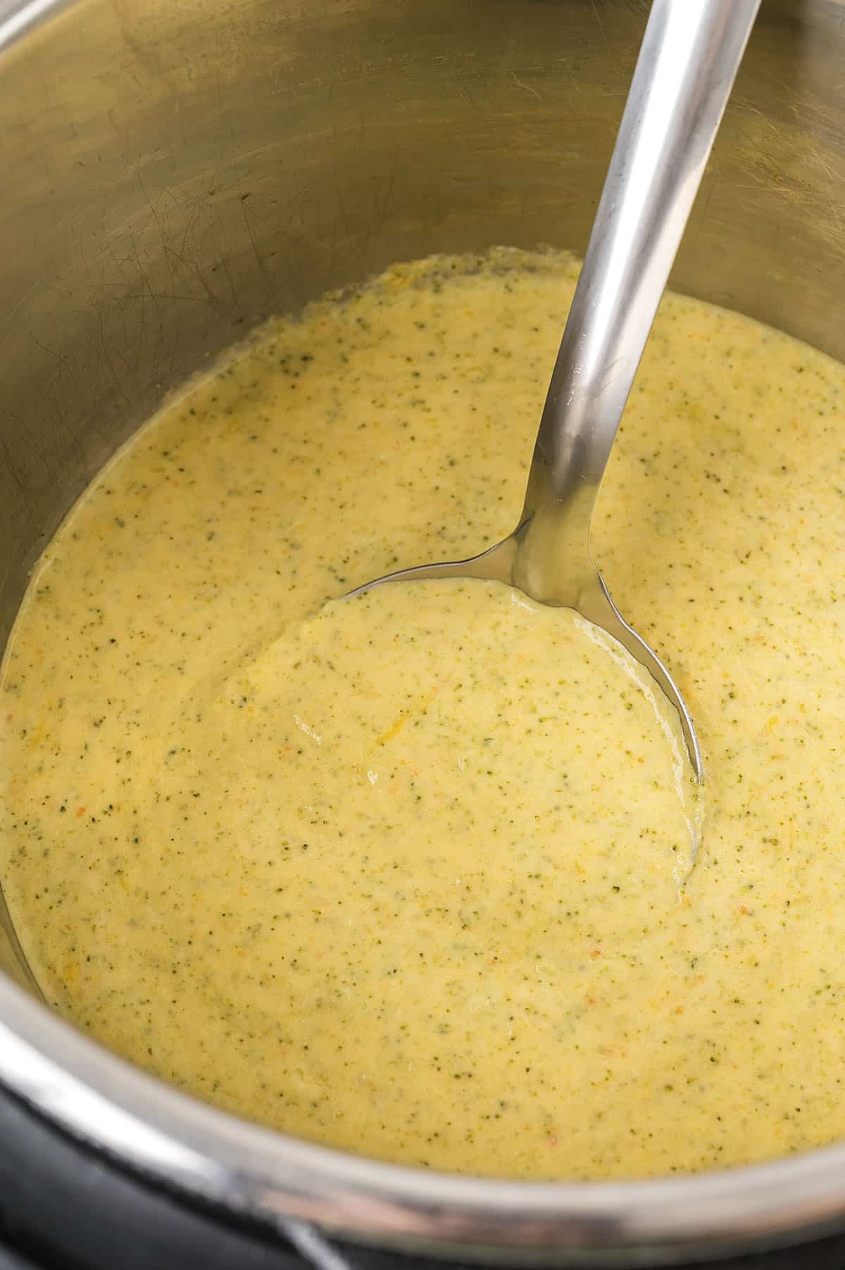 Instant Pot broccoli cheddar soup on ladle.