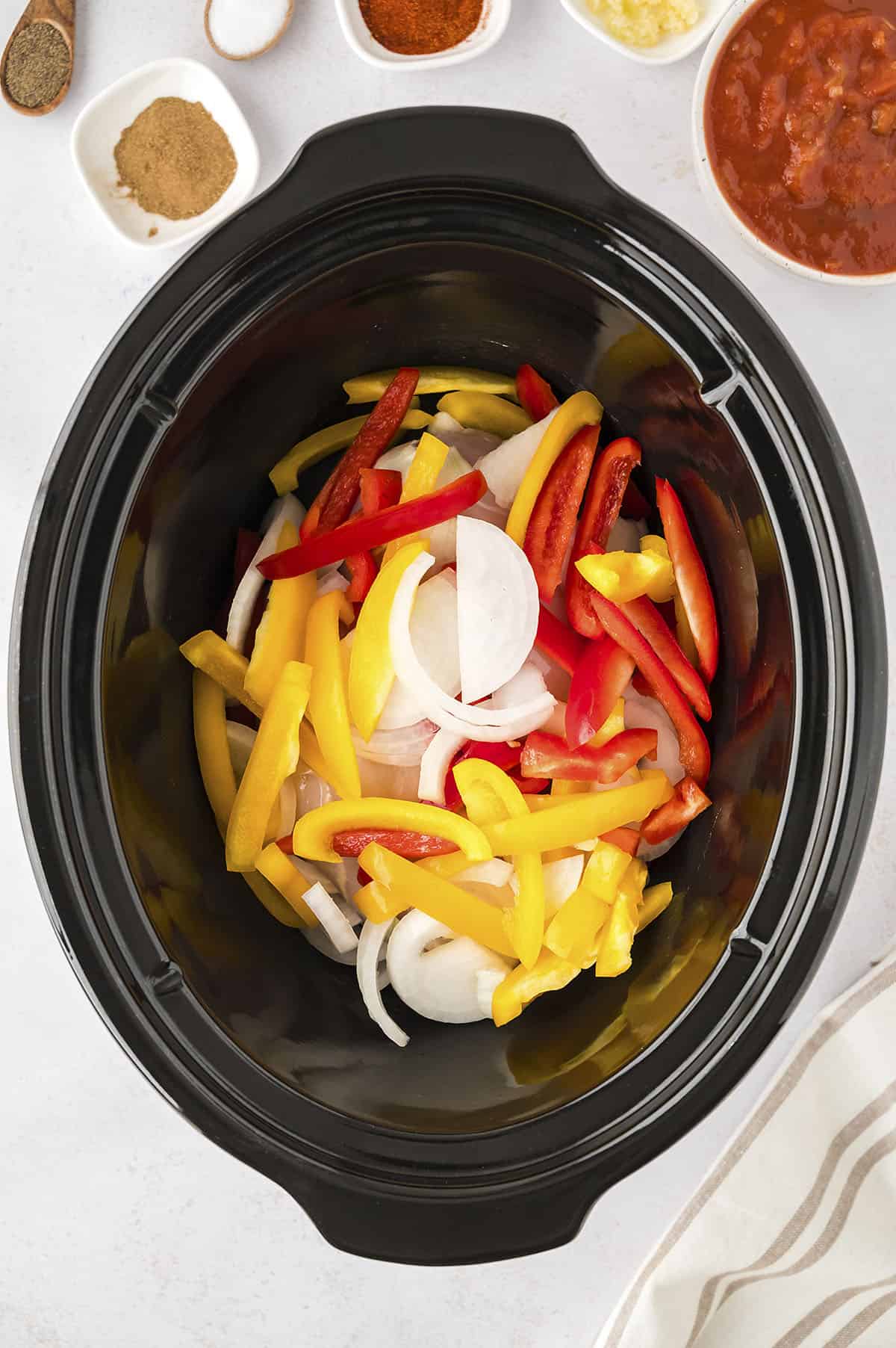 Onions and peppers in crockpot.