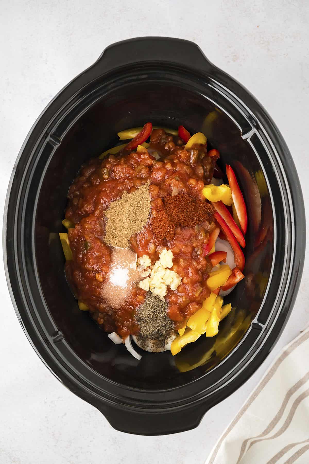 Ingredients for crock pot chicken fajitas in slow cooker.