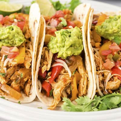 Slow cooker chicken fajitas in tortillas.