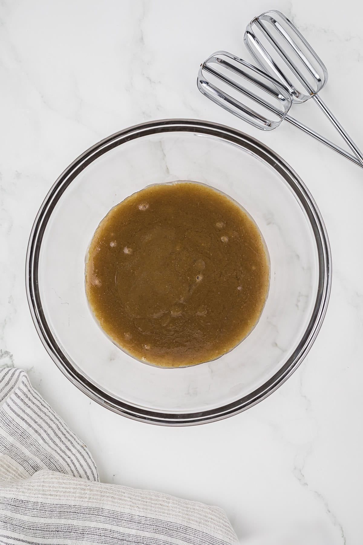 Melted butter and sugar combined in mixing bowl.