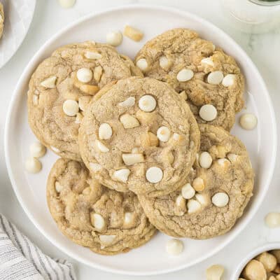 Plate full of white chocolate macadamia nut cookies.