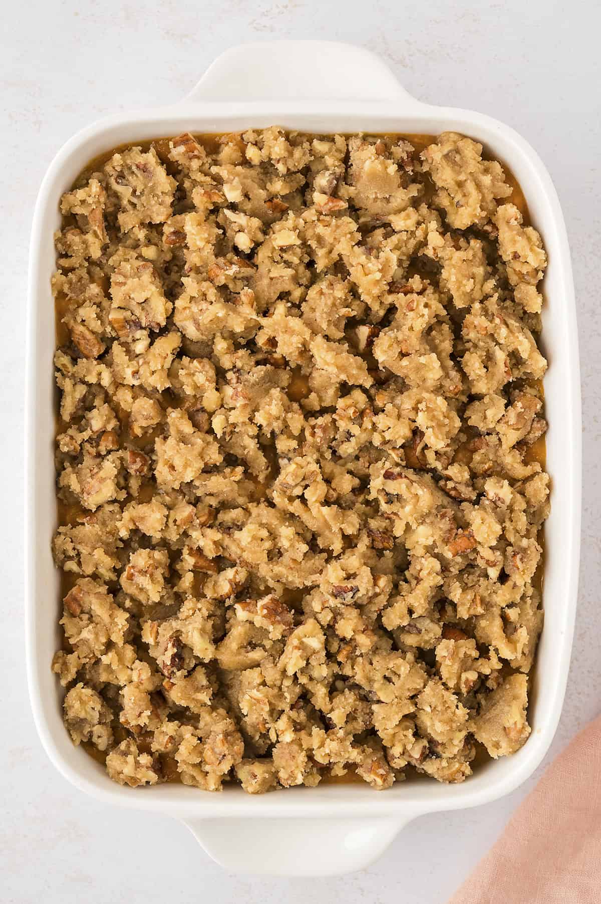 Sweet potato casserole before baking in white baking dish.