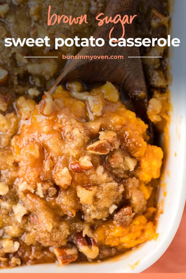 Streusel topped sweet potato casserole on wooden spoon.