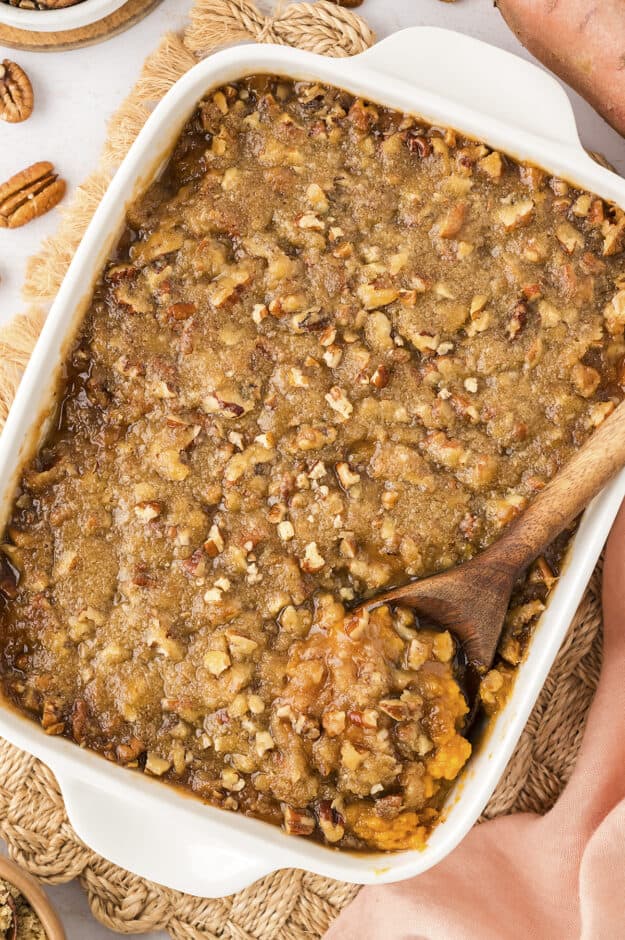 Baked sweet potato casserole recipe in white baking dish.