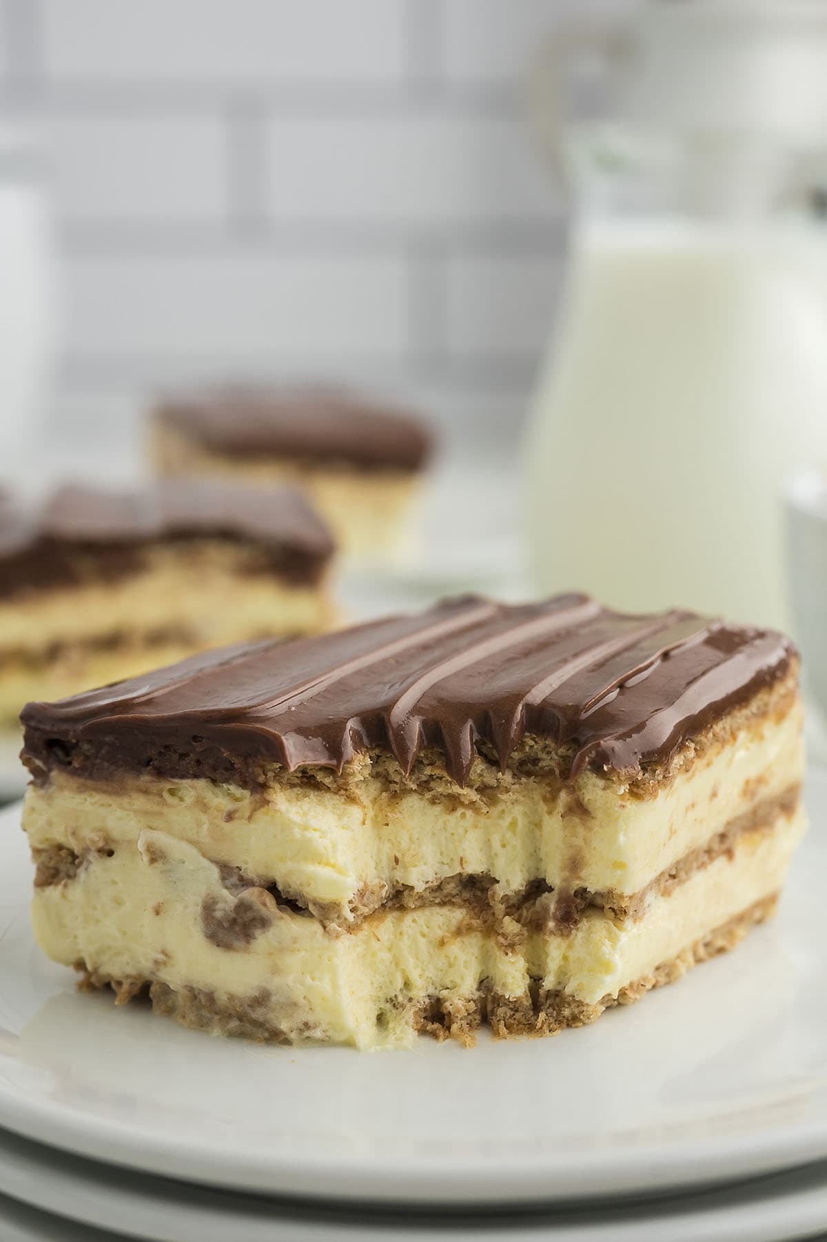 No bake eclair cake on white plates.