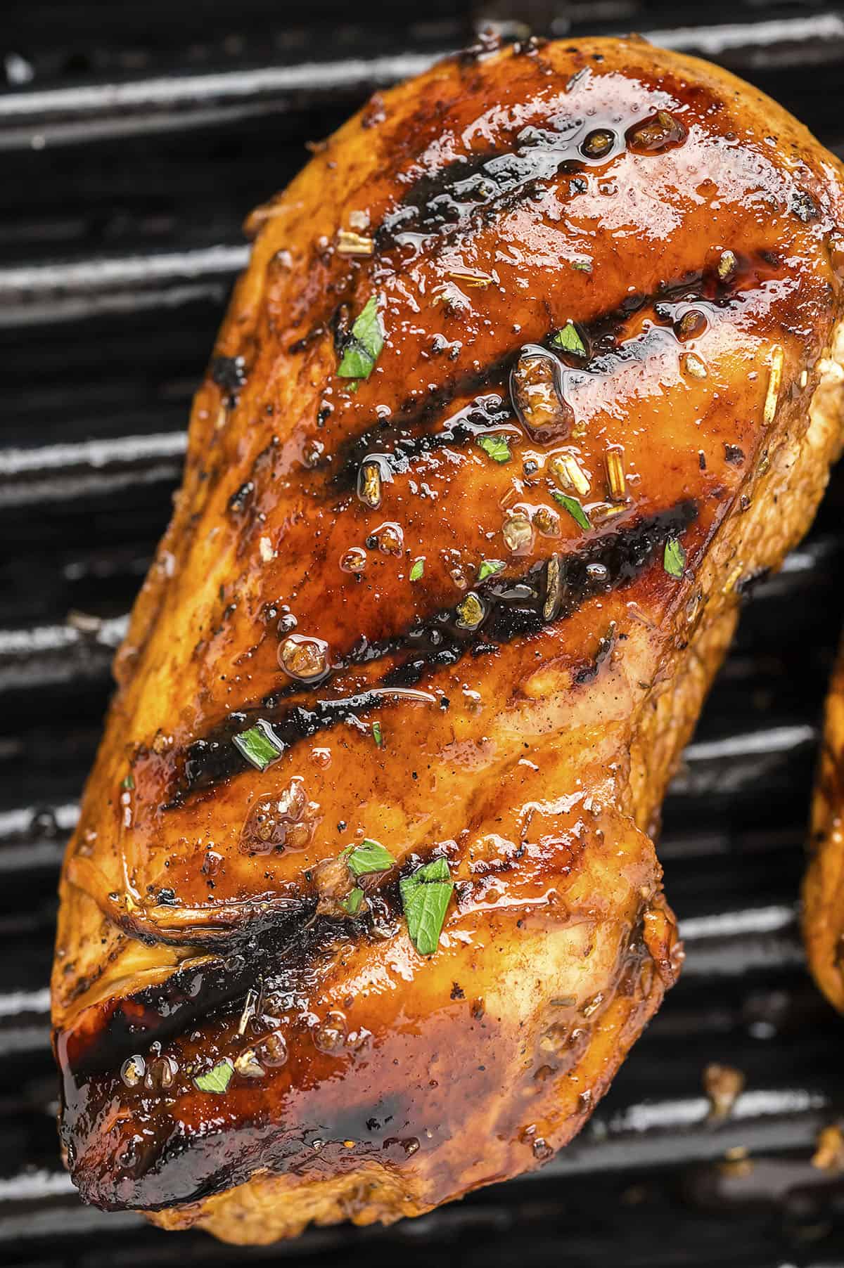 Grilled balsamic chicken on grill.