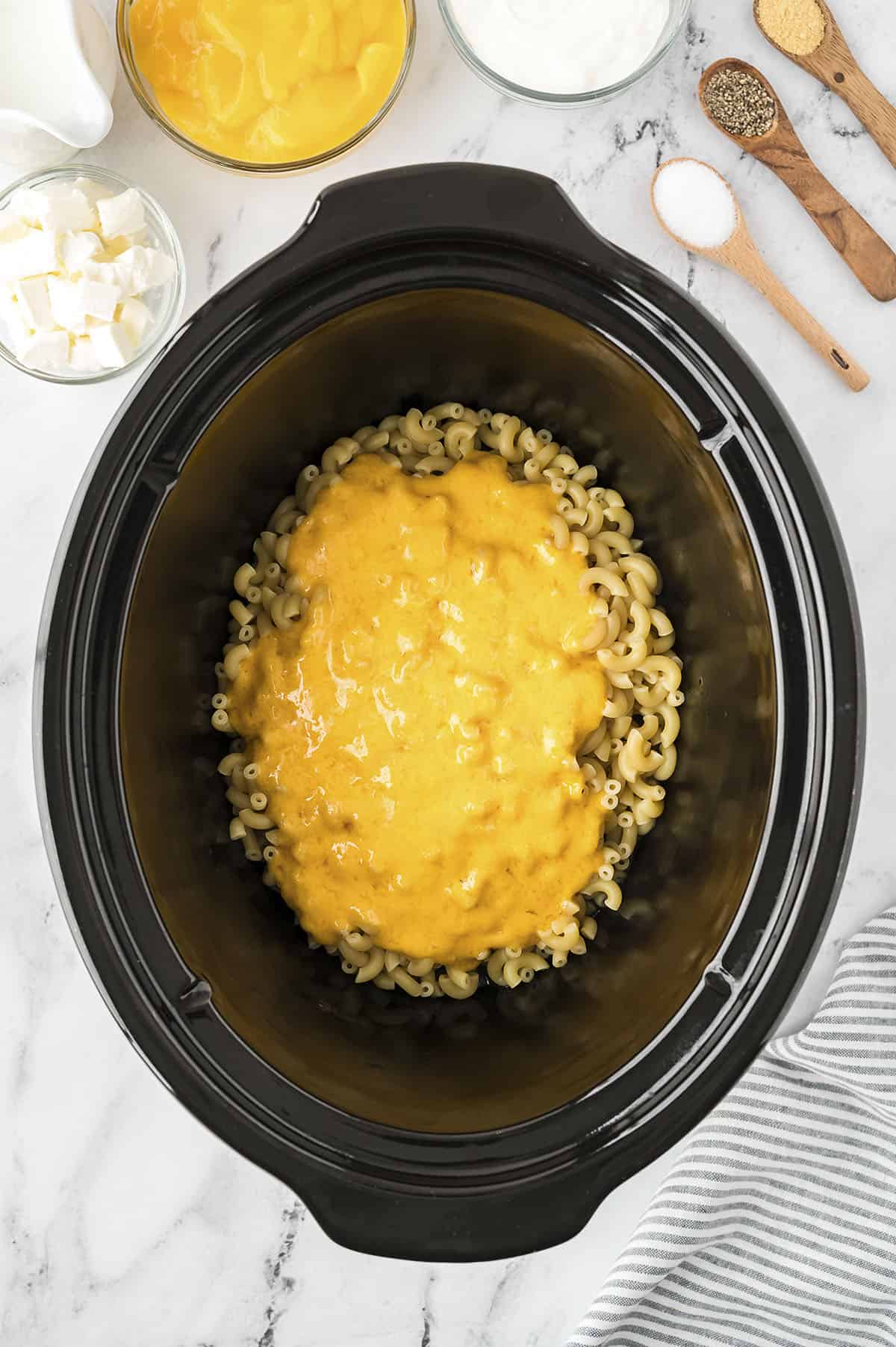 Melted cheese over pasta in crockpot.