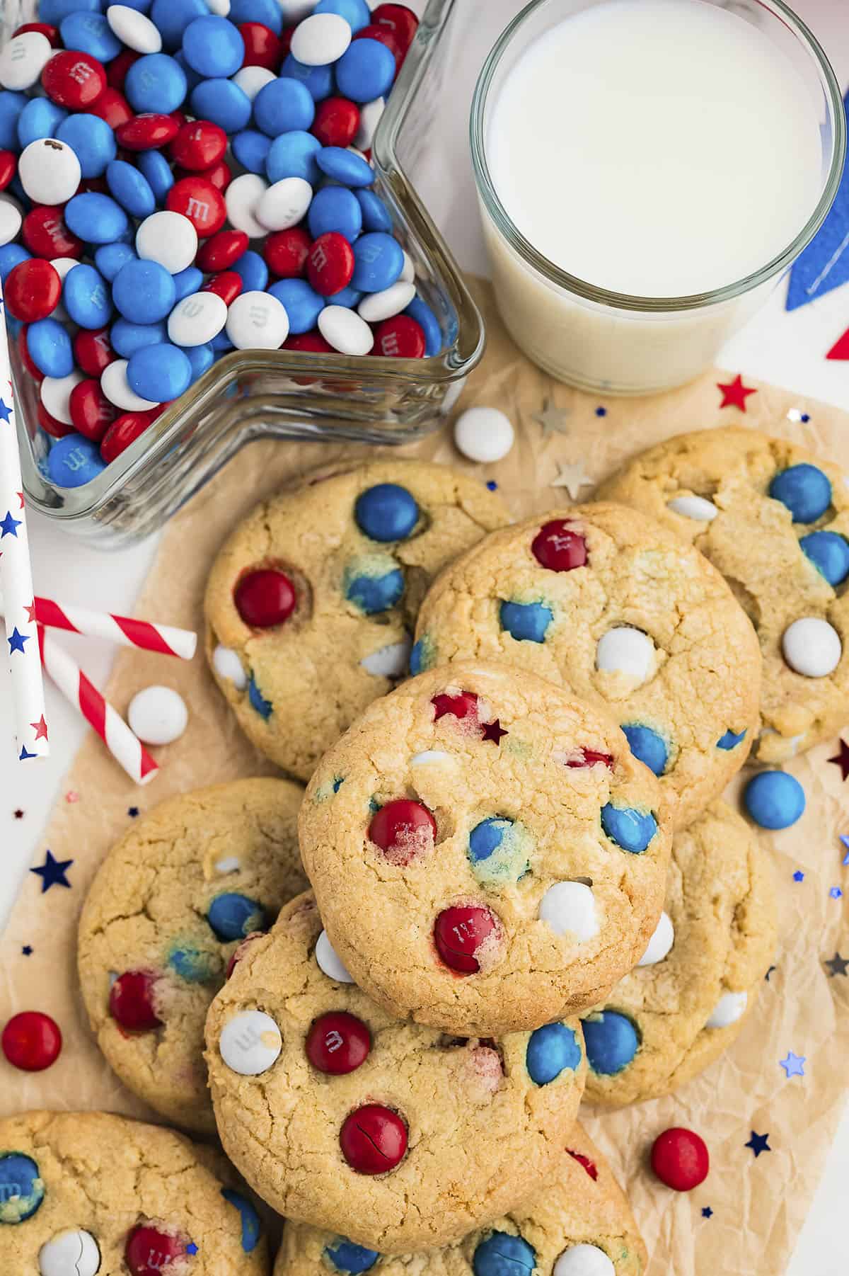 4th of July cookies piled up next to a glass of milk.