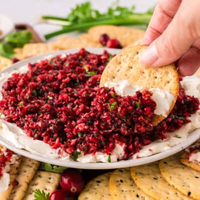 Cranberry cream cheese dip on cracker.