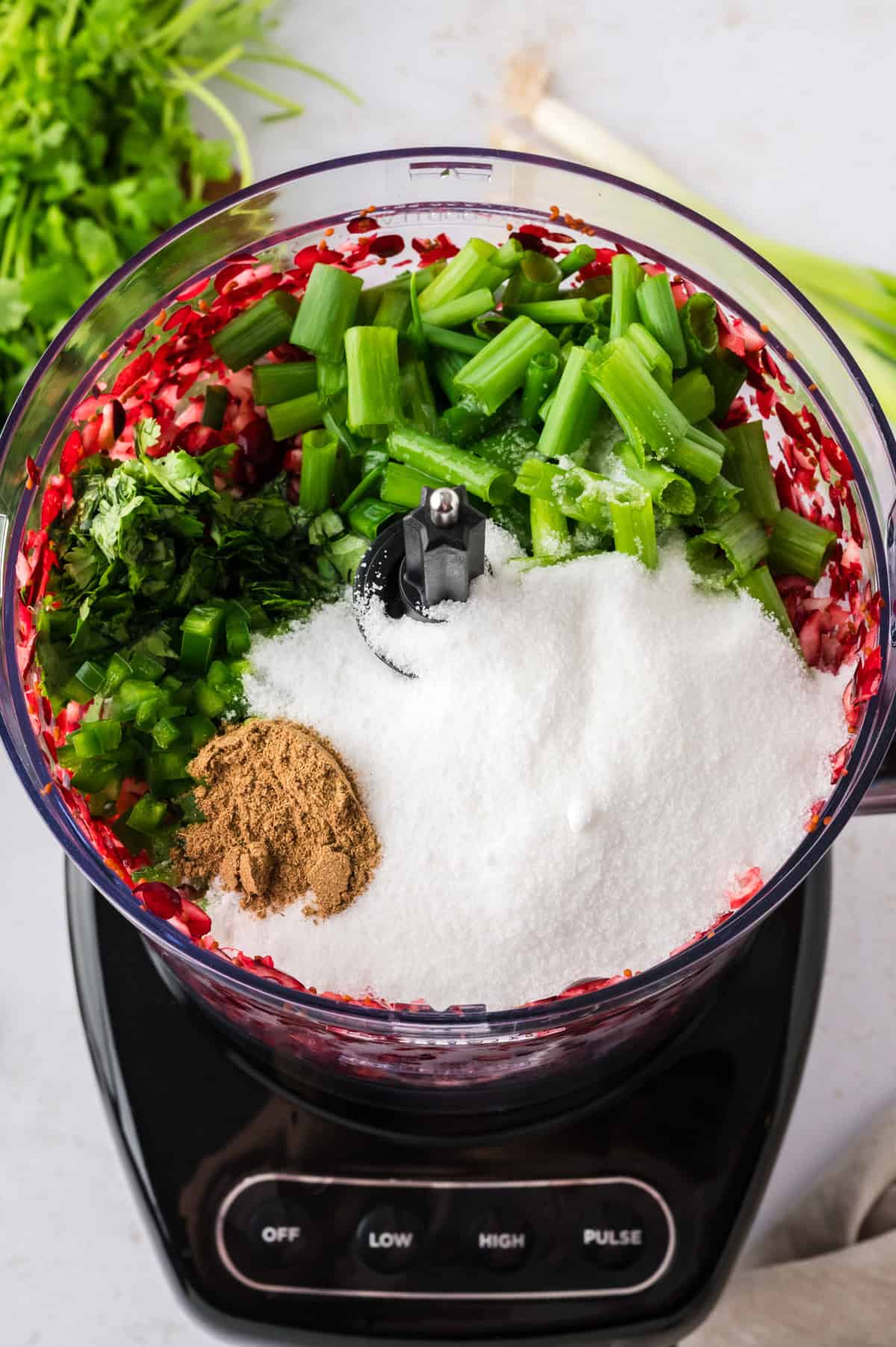 Ingredients for cranberry salsa in food processor.