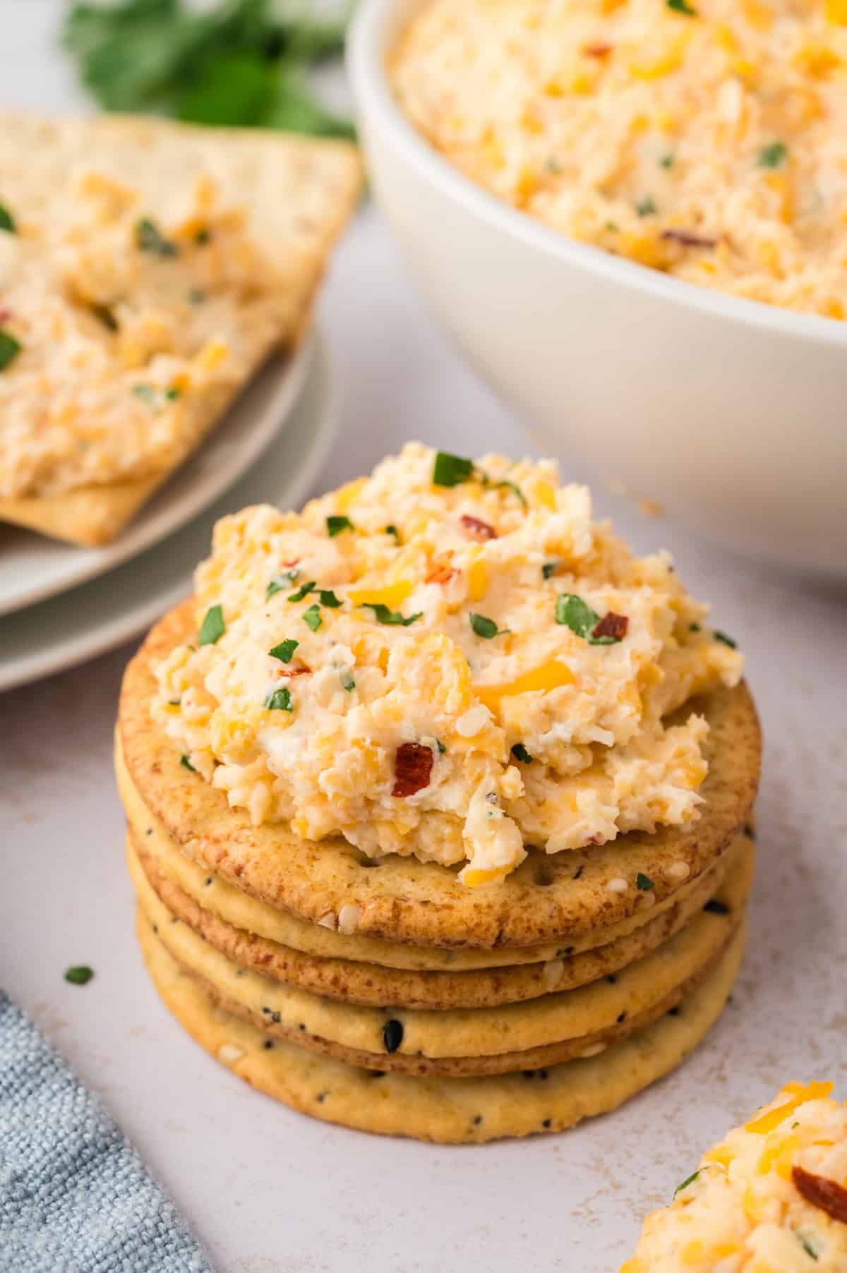 Cracker topped with cheese spead.