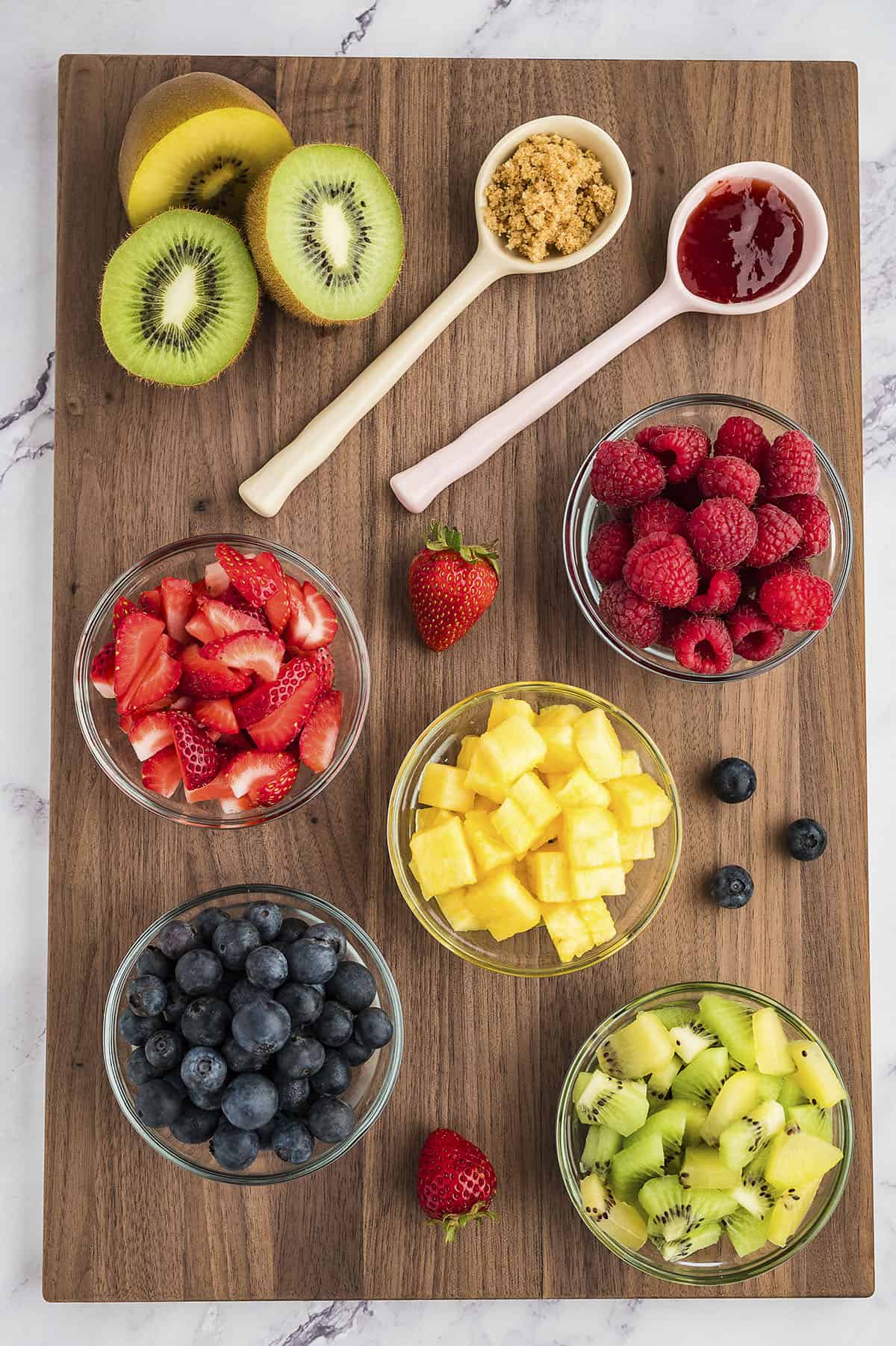 Ingredients for fruit salsa laid out on cutting board.