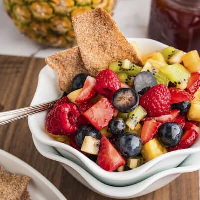 Fruit salsa in bowl with pita chips.