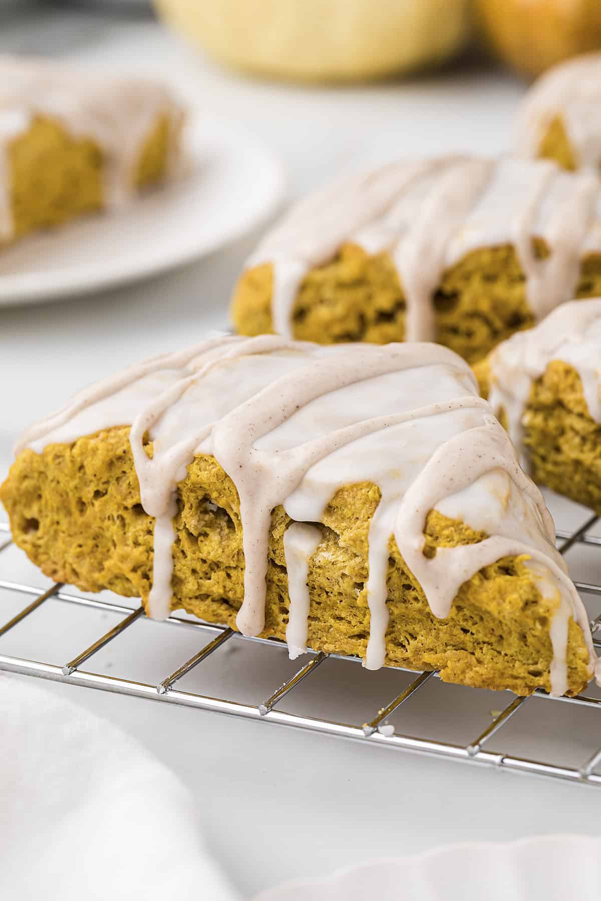 Glazed pumpkin scone on cooling rack.