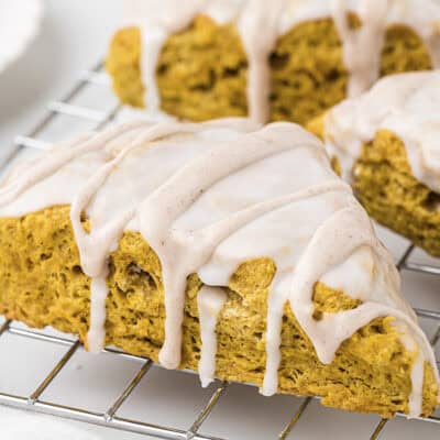 Glazed pumpkin scones on cooling rack.