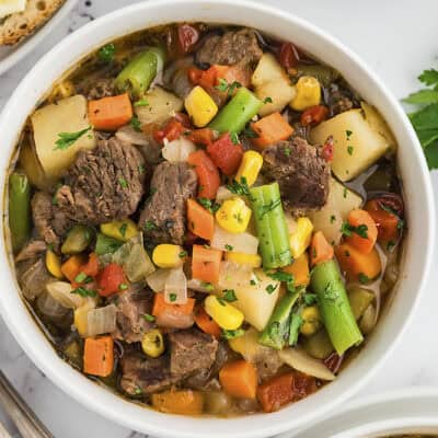 Instant Pot vegetable beef soup in white bowl.