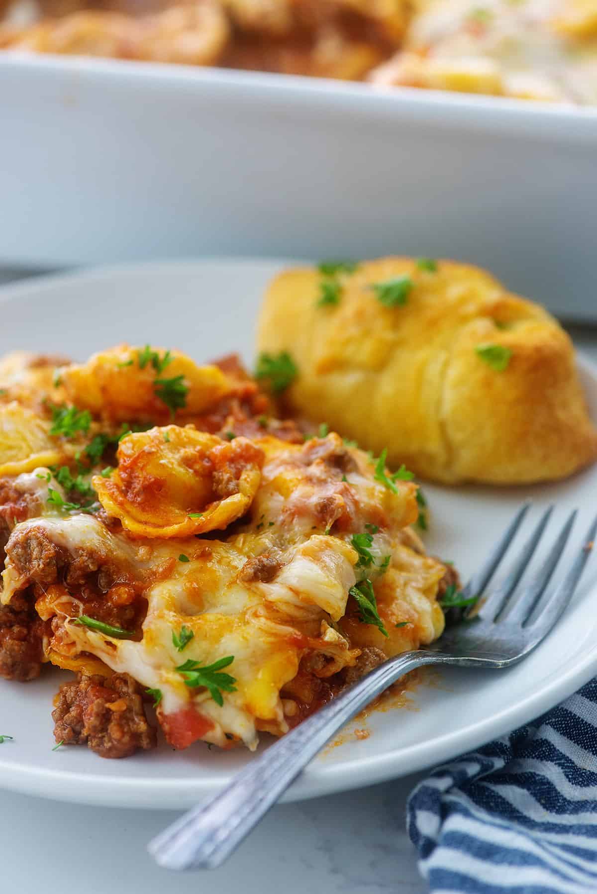 baked tortellini recipe on white plate.