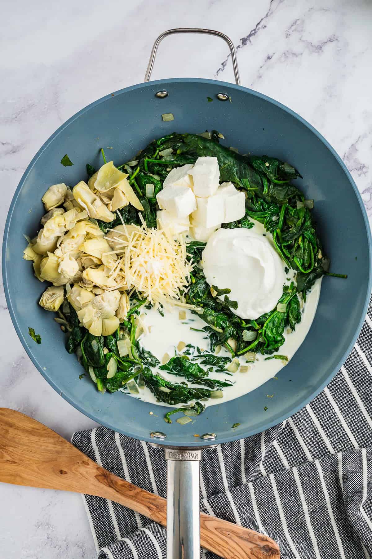 Ingredients for spinach casserole in skillet.