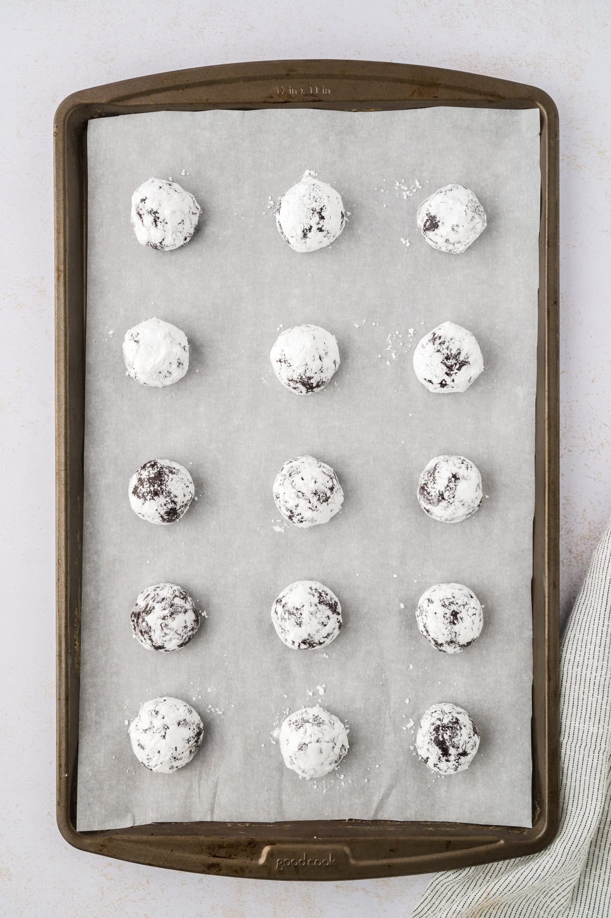 Chocolate crinkle cookie dough rolled in powdered sugar.