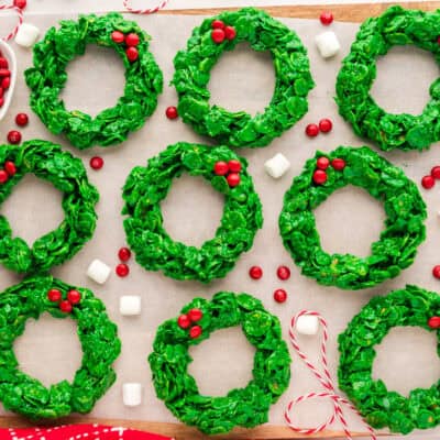 Cornflake wreath cookies on parchment lined cutting board.