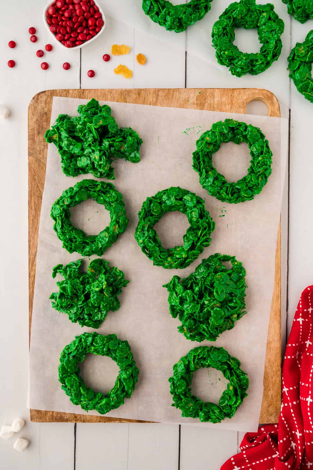 Shaping cornflake wreaths on parchment paper.