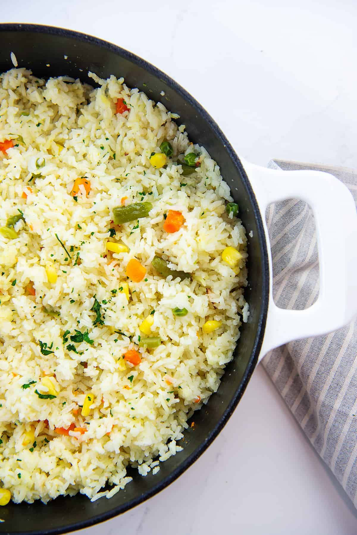 white rice with mixed vegetables in skillet.