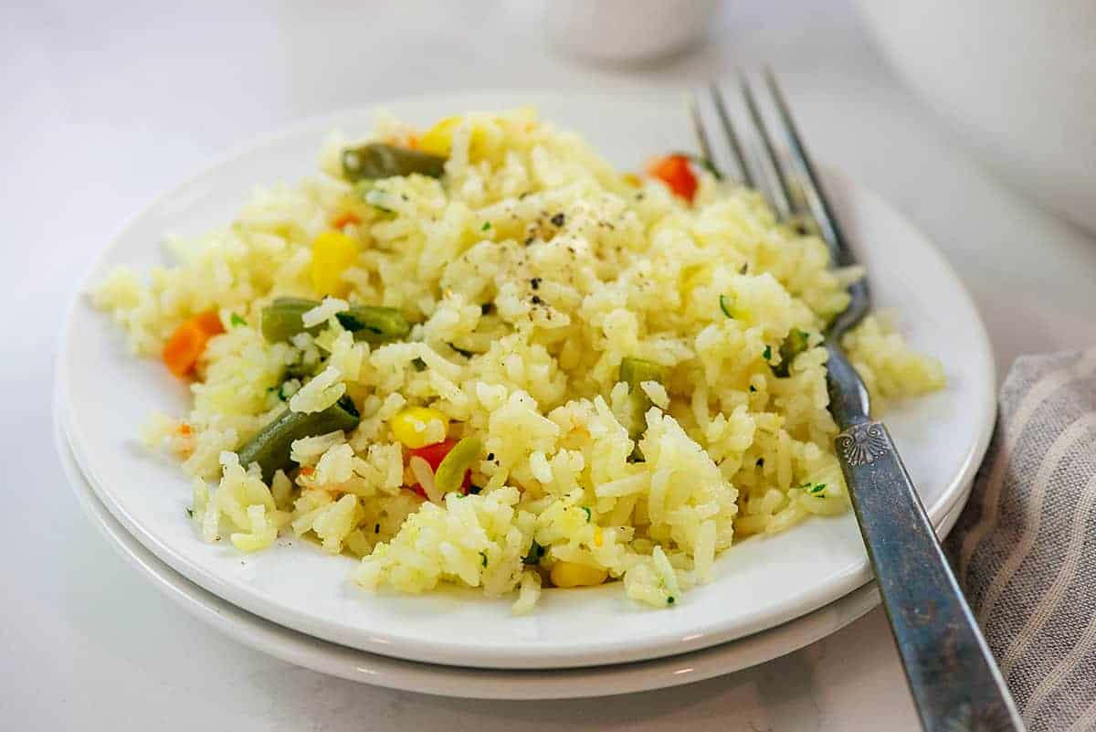 plate full of rice and veggies.