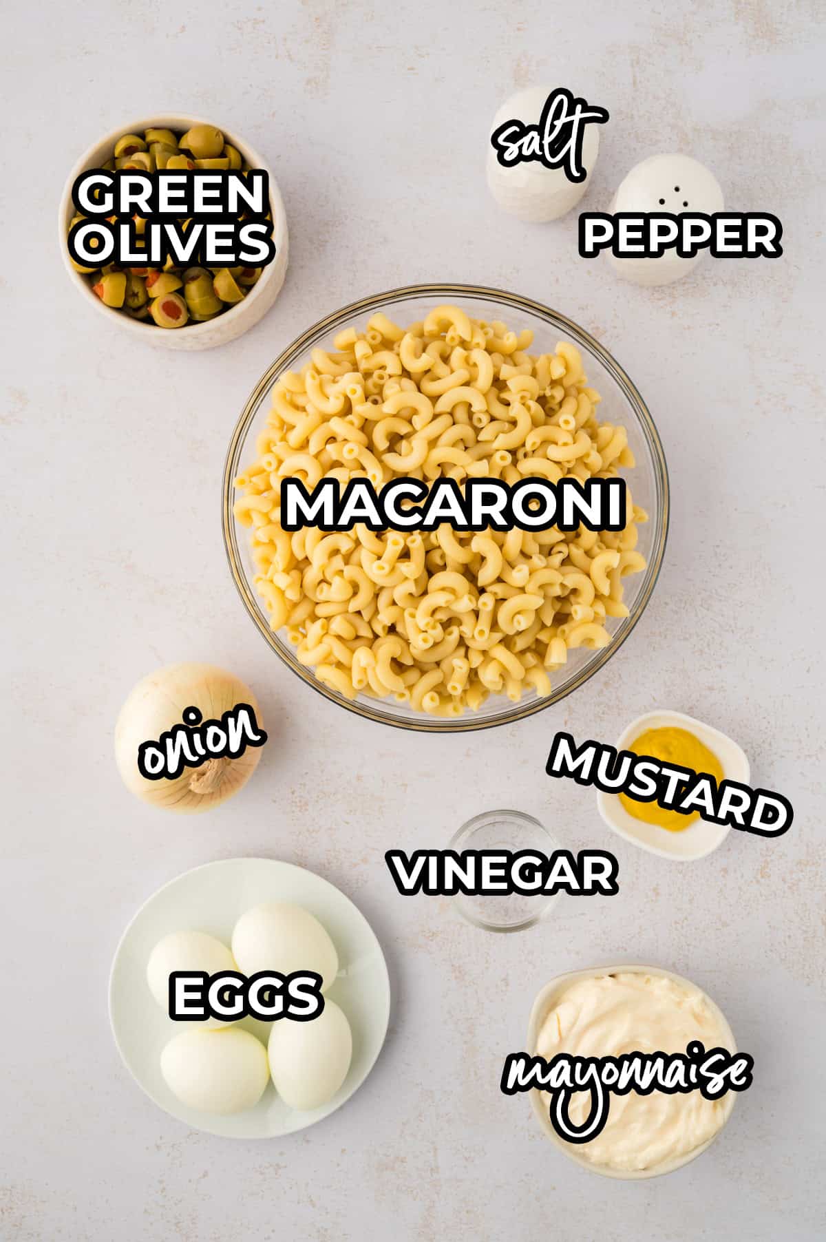 Ingredients for classic macaroni salad recipe with olives.