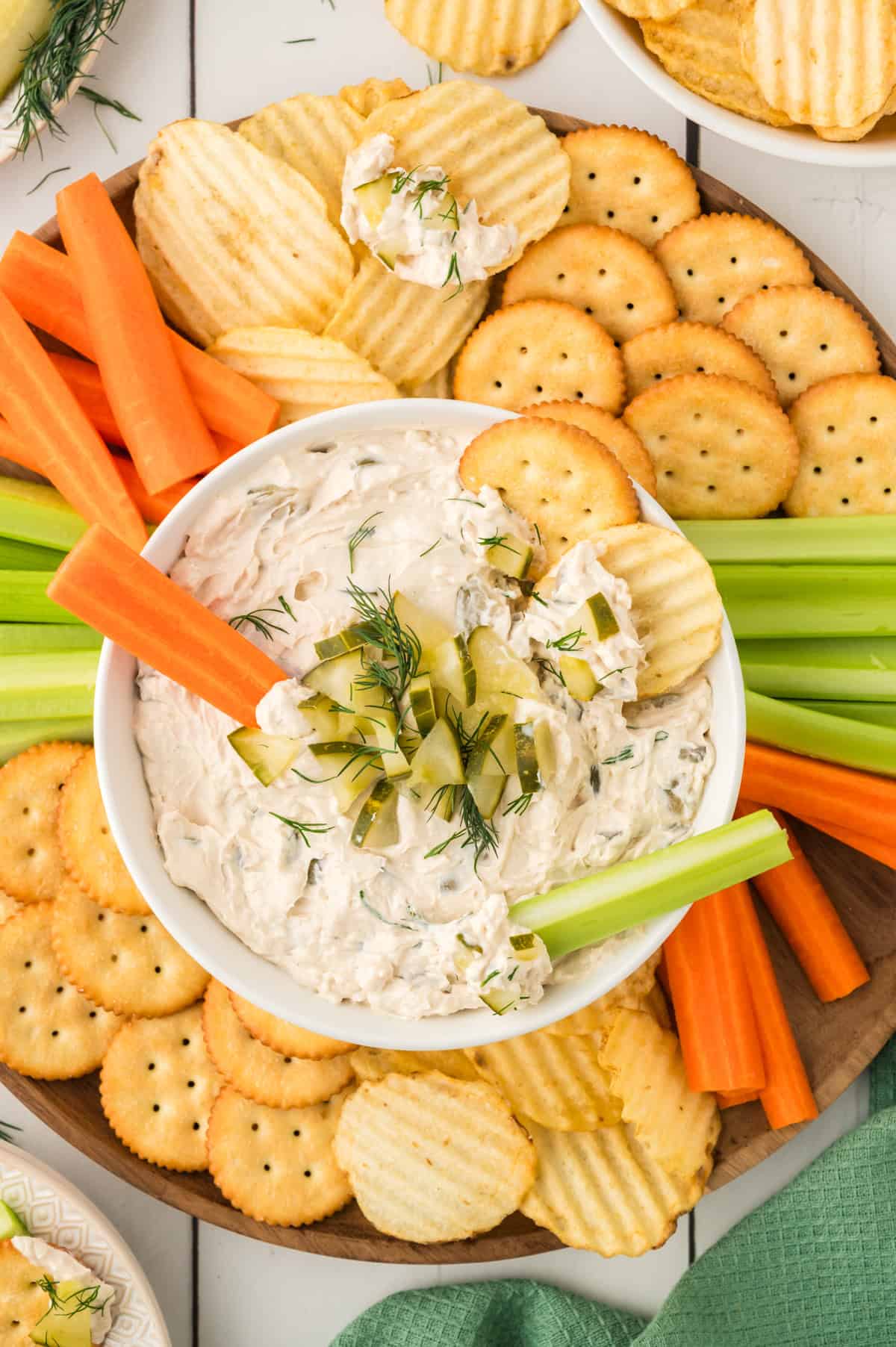 Dill pickle dip in small dish with dippers.