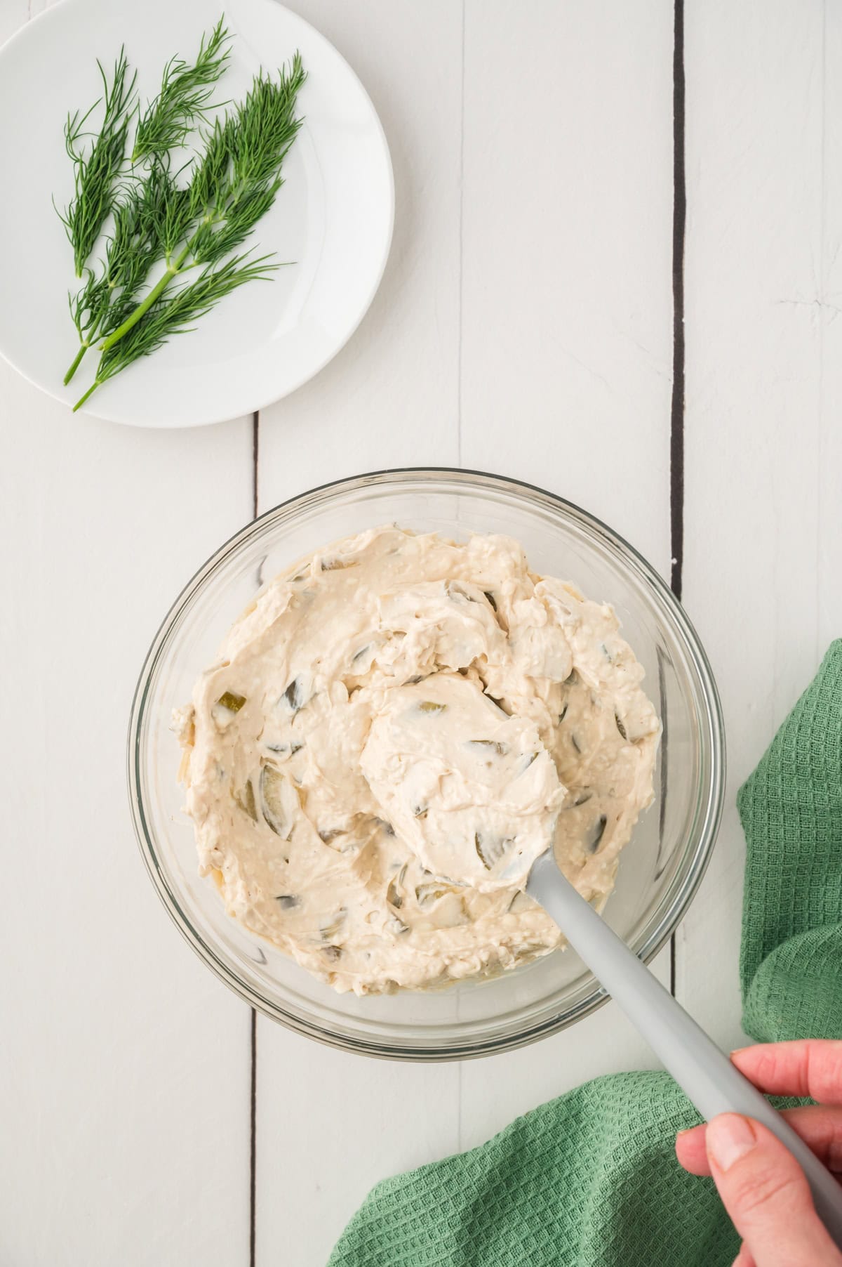 Dill pickle dip being stirred together.