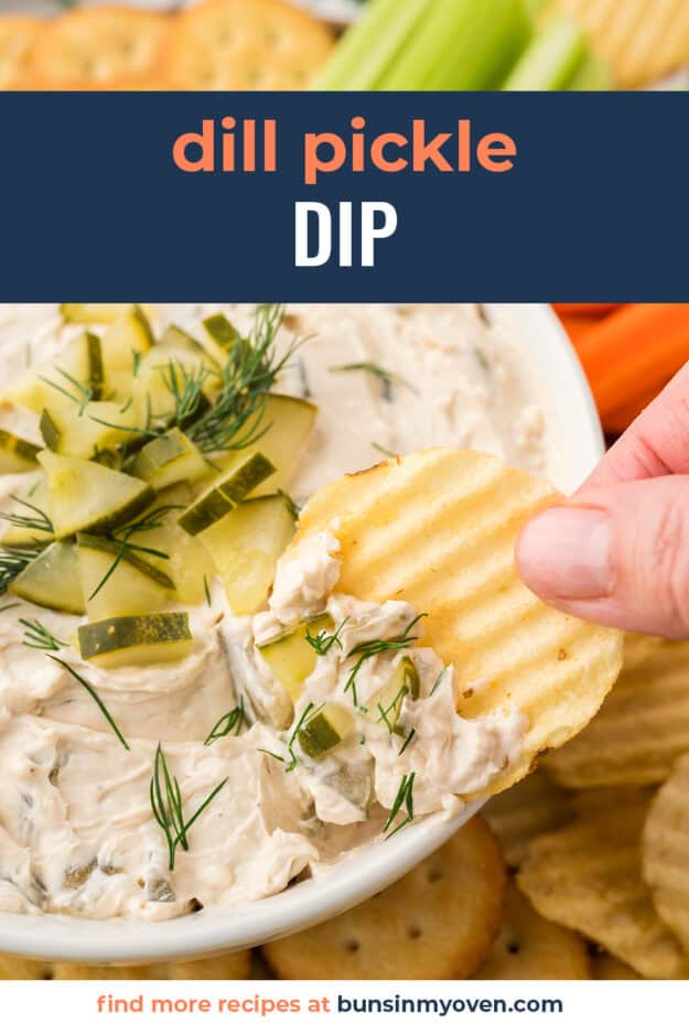 Hand dipping a chip in dill pickle dip.