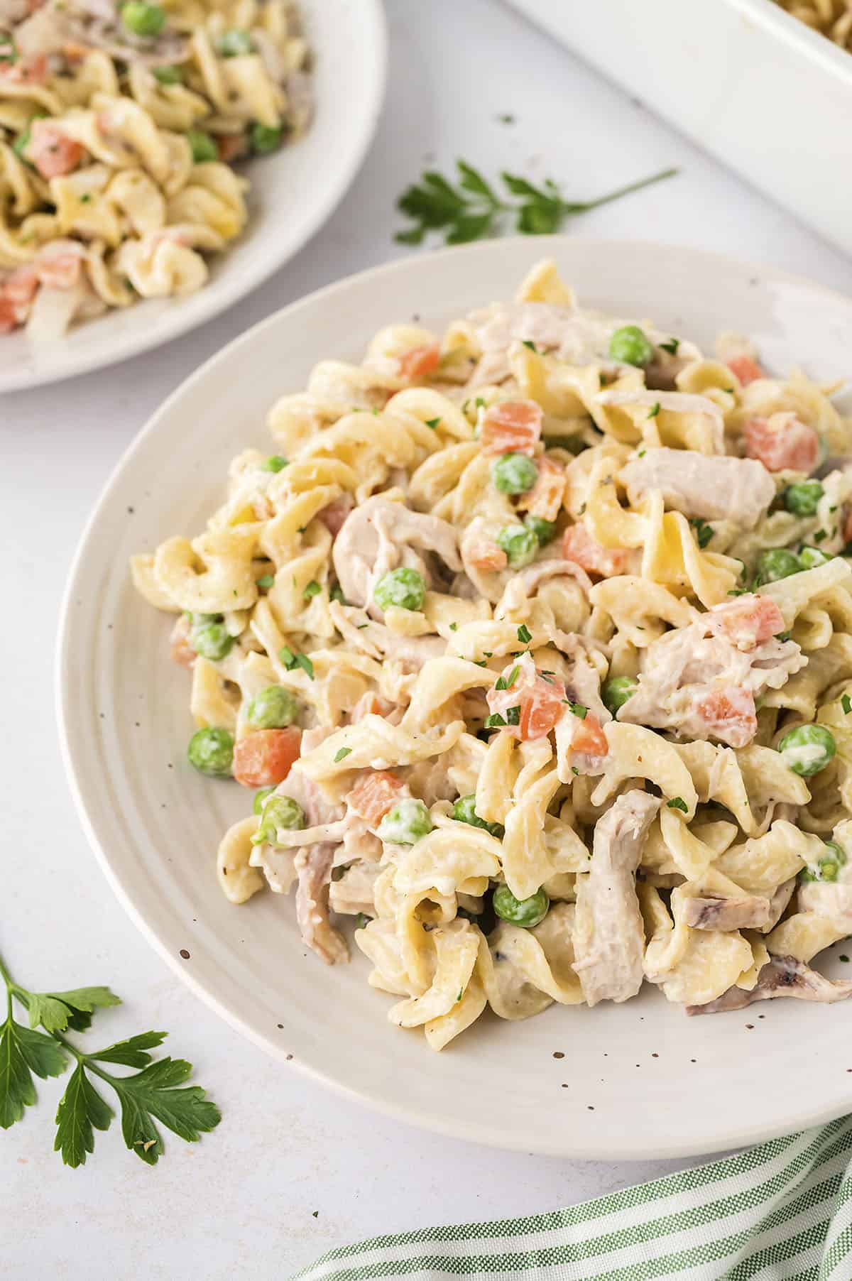 Chicken noodle casserole on white plate.