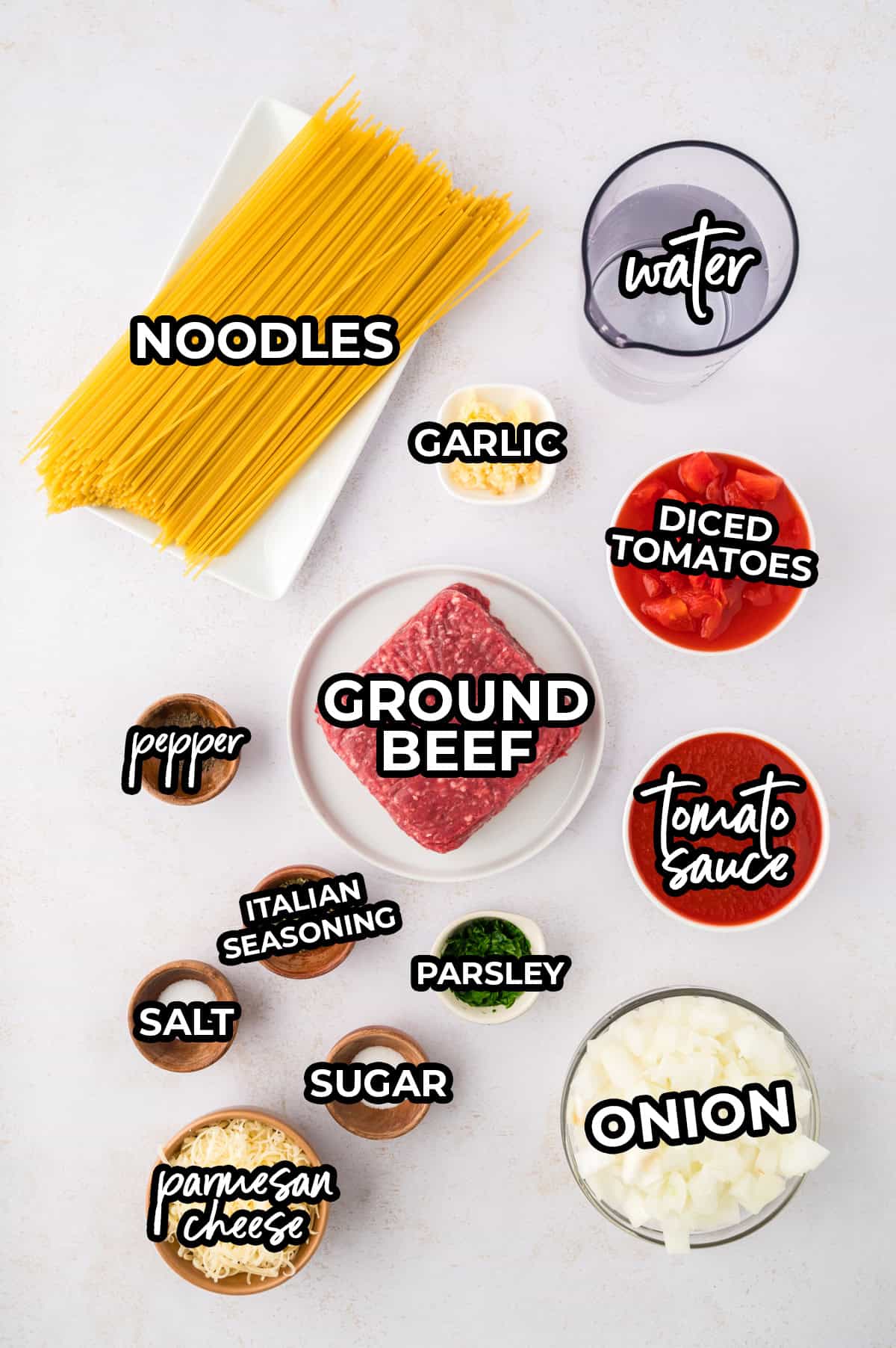 Ingredients for one pot spaghetti laid out in bowls on counter.