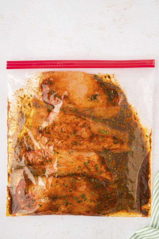Chicken in marinade in ziptop bag.