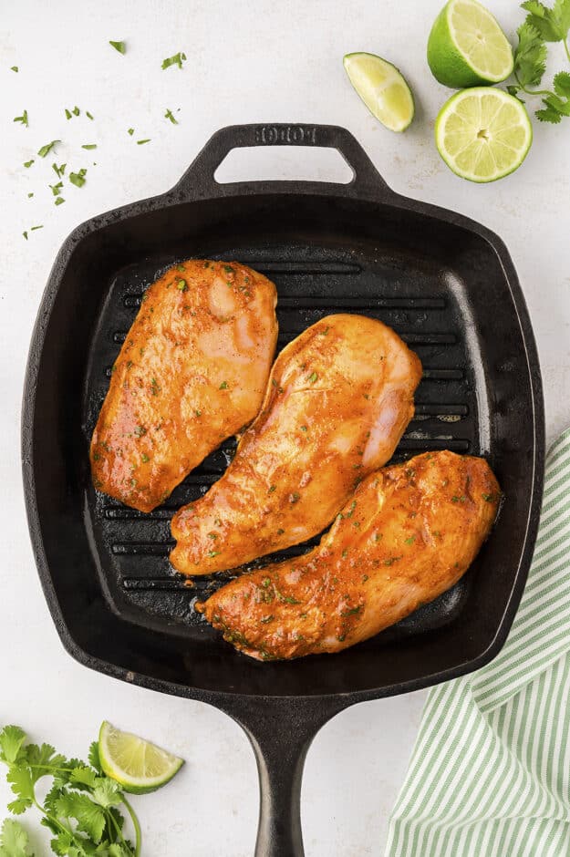 Chicken being grilled on grill pan.
