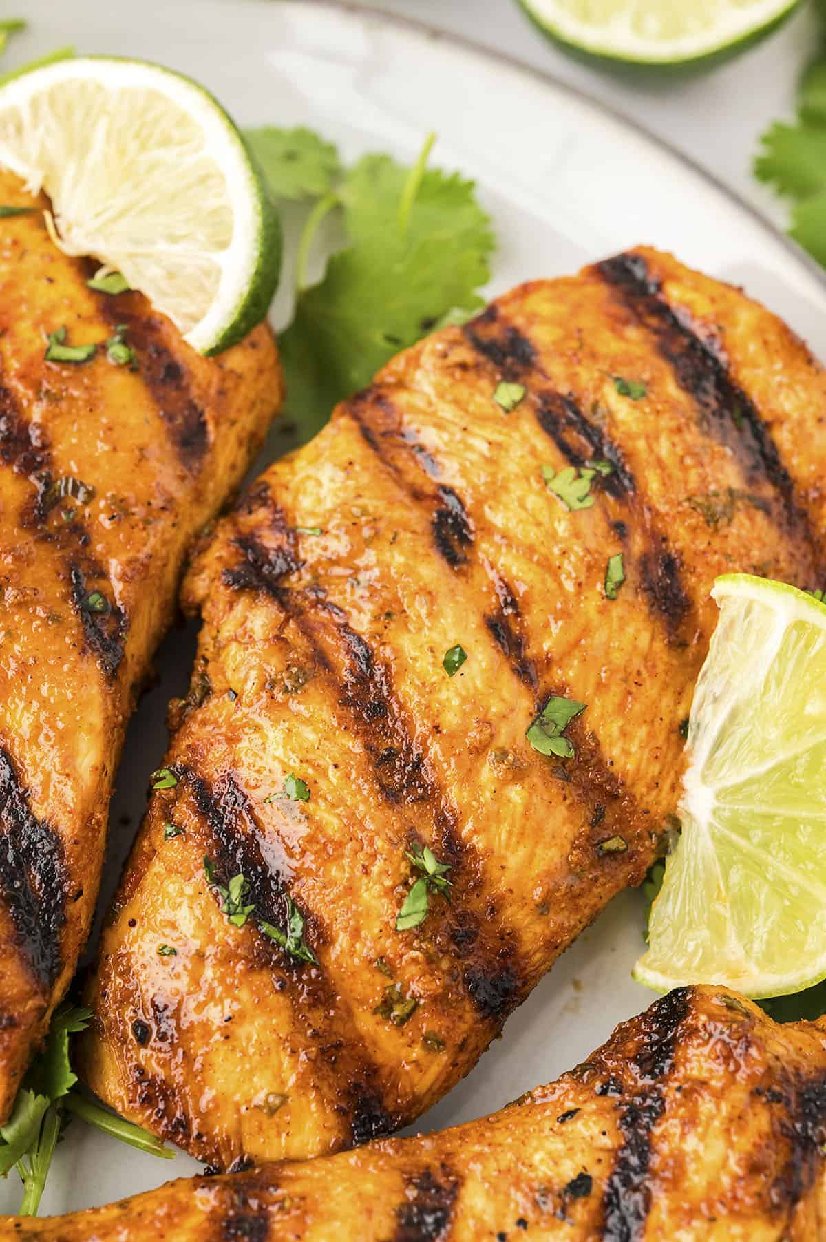 Cilantro lime chicken breasts on plate.